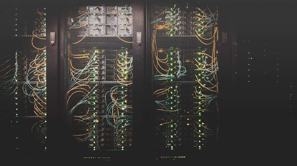 Rows of illuminated server racks inside a large data centre